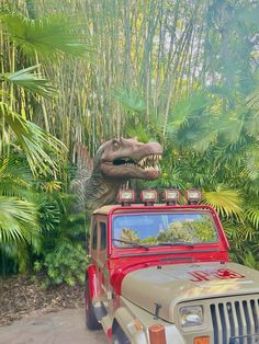 there is a dinosaur on top of a jeep in the jungle with trees and plants behind it