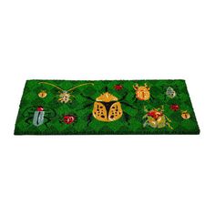 a green rug with bugs and ladybugs on it