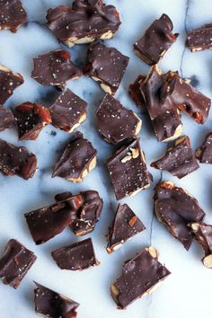 pieces of chocolate and nuts on a marble surface