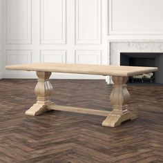 a wooden table sitting on top of a hard wood floor next to a fire place