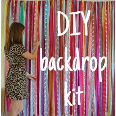 a woman standing in front of a colorful backdrop with the words diy back drop kit