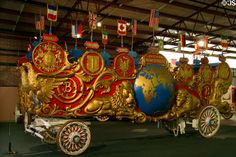 an elaborately decorated horse drawn carriage in a building