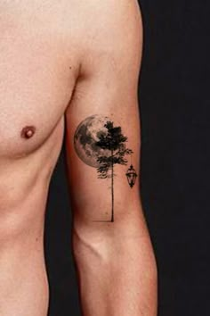 a man with a tree and street light tattoo on his arm