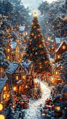 a christmas tree in the middle of a snowy village with lit lights on it's trees