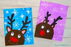 two paper bags with reindeer faces on them, one is purple and the other is blue