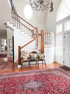 an ornately decorated entryway with chandelier and rug