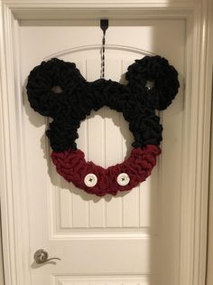 a mickey mouse wreath hangs on the front door to give it a disney world feel