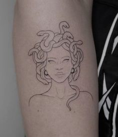 a woman's face with braids on her arm and behind it is a tattoo