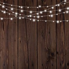 string lights are hanging on a wooden wall with wood planks in the foreground