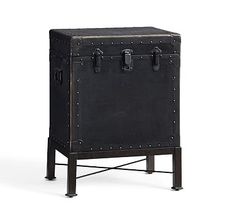 an antique trunk with metal studs on the front and sides is shown in black