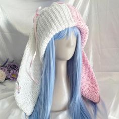 a wig with blue hair wearing a knitted hat