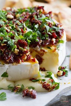 some food that is on top of a white plate with crackers in the background