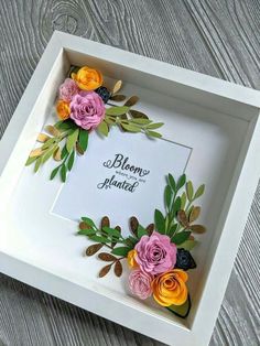 a white box with some flowers in it