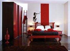 a bedroom with red accents and white walls