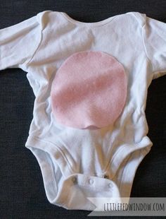 a baby bodysuit with a pink circle appliqued on the front and back