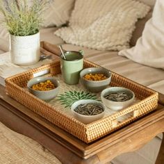 a tray that has some food in it on top of a table next to a couch