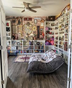 a room that has a bed in it and many books on the shelves behind it