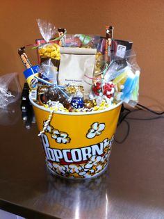 a popcorn bucket filled with snacks and candy