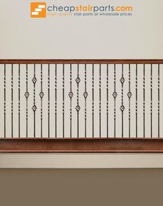 an image of a stair railing with wood and metal rails on the bottom floor in front of a white wall