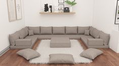 a large gray couch sitting on top of a wooden floor next to a white rug