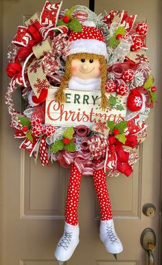 a christmas wreath with a doll hanging from it's side on the front door