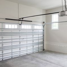 an empty garage with two overhead lights and no one in the room or on the floor