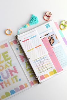 an open planner book sitting on top of a table next to scissors and other crafting supplies