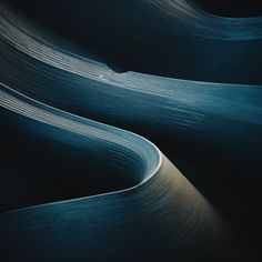 an abstract photo of wavy lines in blue and black colors, taken from the ground