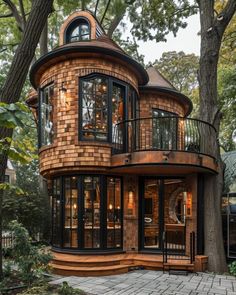 a round wooden house surrounded by trees