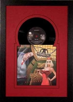 a red frame with an image of a man and woman in the center, on top of a wall