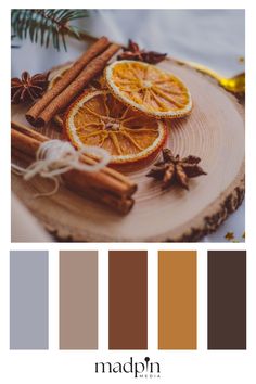 an orange slice and cinnamon sticks on a wooden plate