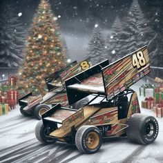 a christmas tree is in the background with two racing cars