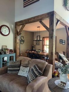 a living room filled with furniture and a clock mounted to the side of it's wall