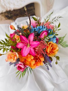 a bouquet of flowers is sitting on the bed