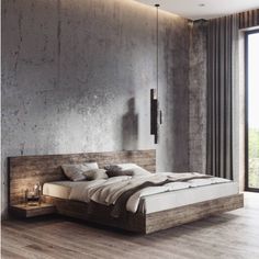 a modern bedroom with concrete walls and wood flooring, along with a white rug on the floor