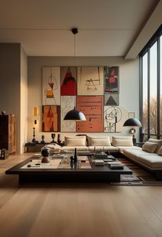 a living room filled with furniture and large windows