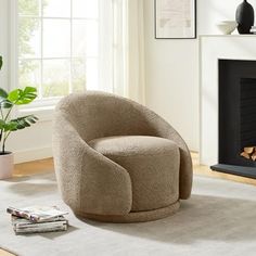 a living room with a chair, fireplace and potted plant on the floor in front of it