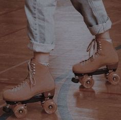 a pair of roller skates with laces on them are standing in the middle of a gym floor