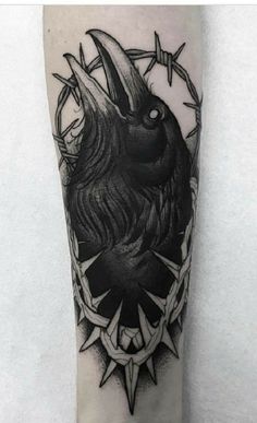 a black and white tattoo on the leg of a person with a bird in it's head