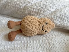 a stuffed animal laying on top of a bed