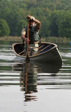 a man is paddling his boat in the water