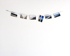 several polaroid photos hanging on a clothes line