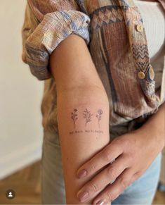 a woman with a small tattoo on her arm