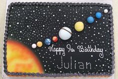 a birthday cake decorated with planets and the words happy birthday to all of us on it