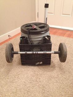 a cart that is sitting on the floor in front of a door with wheels attached to it