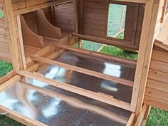 the inside of a chicken coop with its doors open