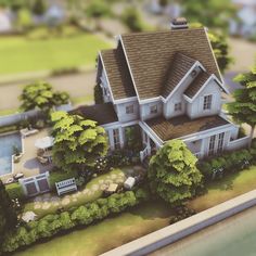 an aerial view of a large house with lots of trees on the front and side