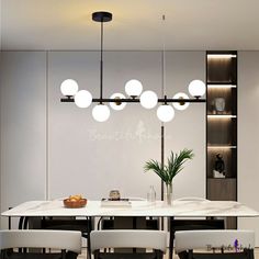 a modern dining room with white chairs and an oval marble table surrounded by hanging lights