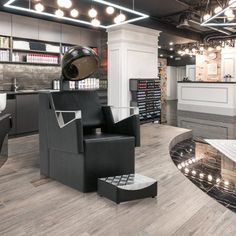 the interior of a nail salon with chairs, lights and counter top space for manicures