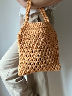 Add a pop of color and personality to any outfit with our eye-catching crochet tote bag. From the bustling city streets to laid-back weekends, its playful design effortlessly complements your style, turning heads wherever you go. Effortlessly chic and practical, this handmade  beauty is your go-to accessory. 🎁 Perfect Gift: Surprise your loved ones with a gift they'll cherish forever. Ideal for birthdays, holidays, or just because, our crochet tote bag is sure to delight anyone who appreciates Spring Crochet Bag With Macrame For Everyday Use, Trendy Woven Crochet Shoulder Bag, Yarn Crochet Tote Bag, Orange Crochet Bag With Braided Handles For Everyday Use, Trendy Handwoven Crochet Bag For Everyday, Crochet Cotton Tote Bag, Trendy Handwoven Crochet Bag For Spring, Beige Crochet Bag With Granny Square For Summer, Crochet Yarn Tote Bag